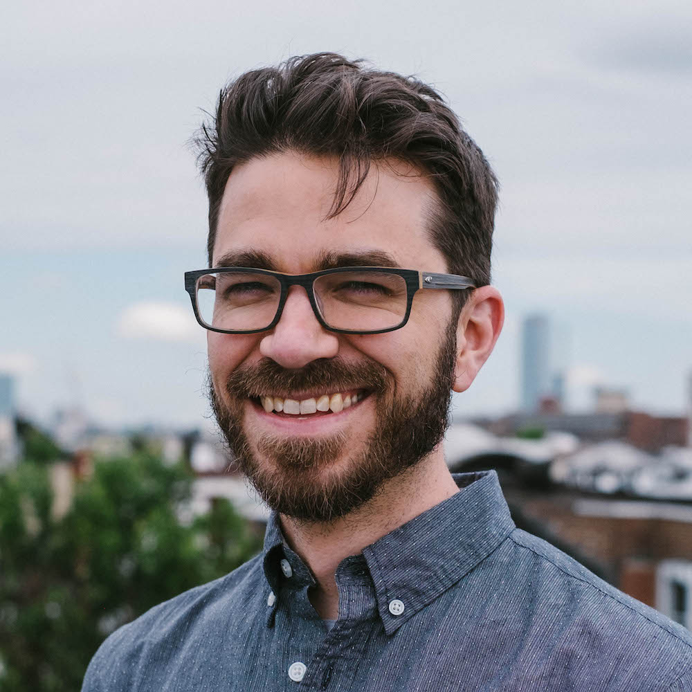 Portrait photo of Alex, bearded guy with glasses